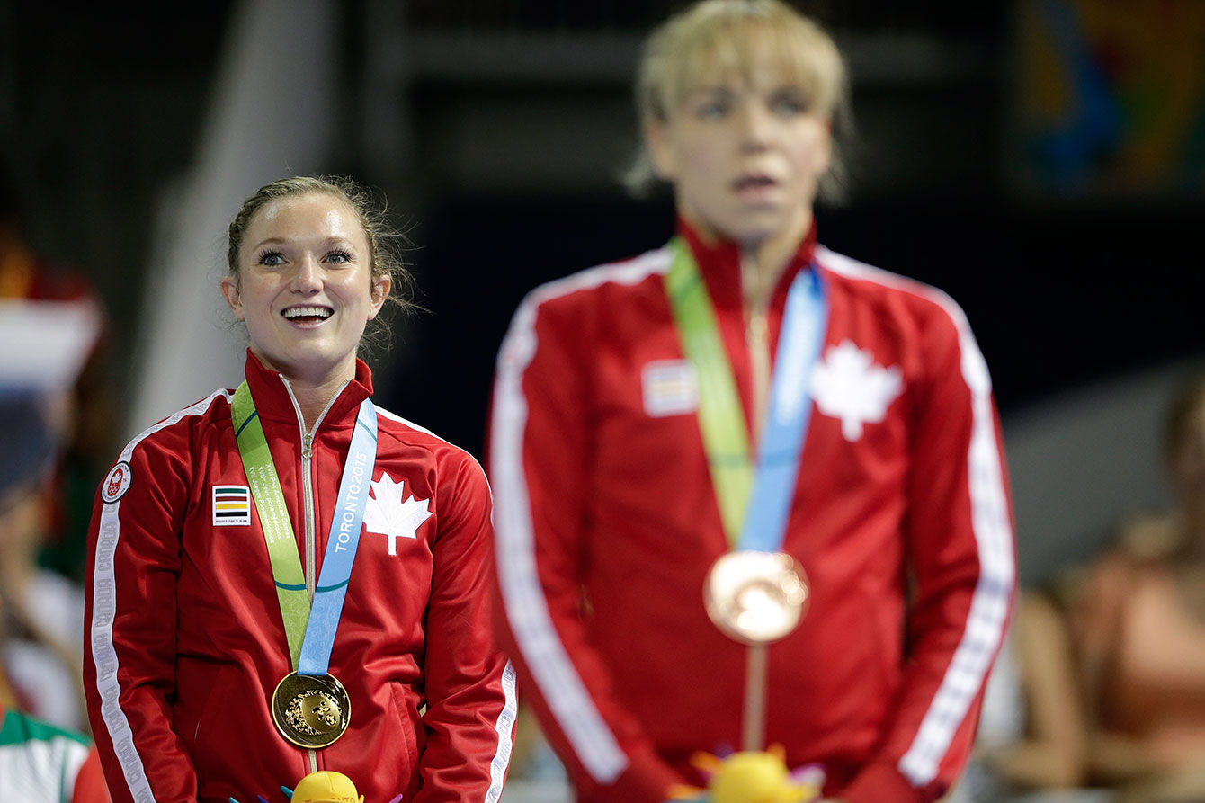 Canada's Rosie MacLennan listens to 'O Canada' after receiving her gold medal at TO2015. Her teammate Karen Cockburn took the bronze. 