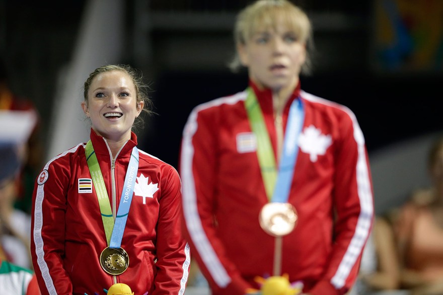 Canada's Rosie MacLennan listens to 'O Canada' after receiving her gold medal at TO2015. Her teammate Karen Cockburn took the bronze.