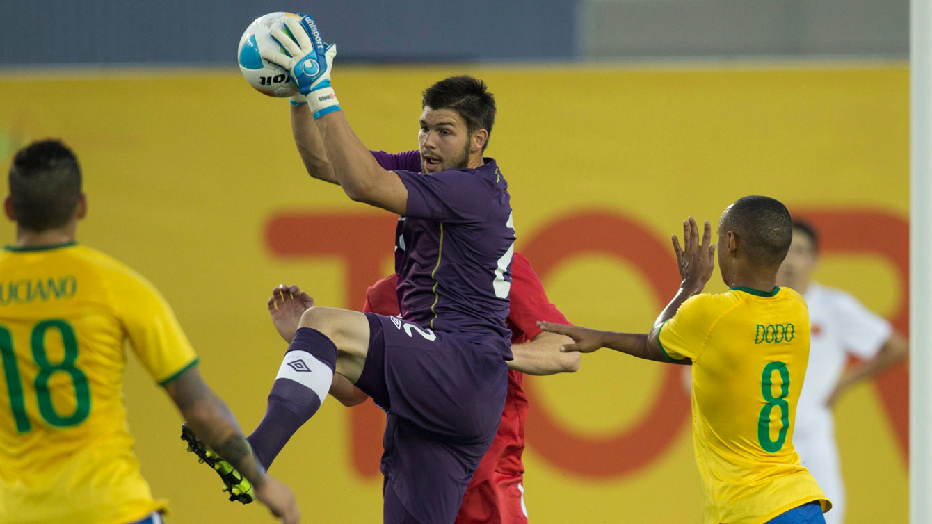 Canadian goalkeeper Maxime Crepeau comes off his line to grab the ball against Brazil in Pan Am Games football on July 12, 2015.