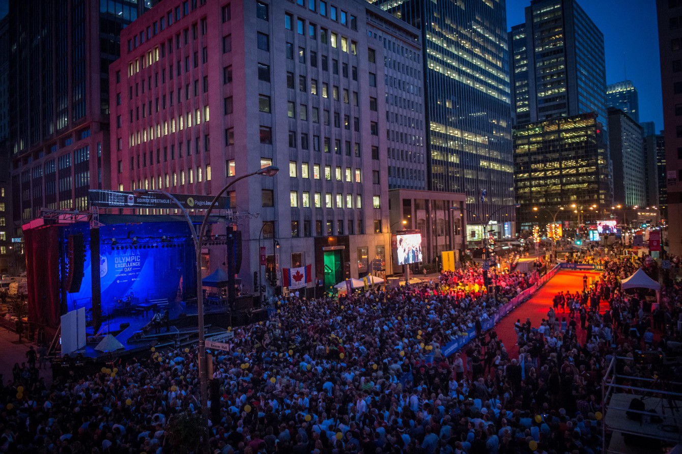 At nightfall fans prepare for the evening show, including the presentation of the Olympic rings on July 9, 2015 in Montreal. 