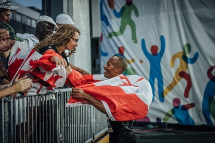 Damian Warner goes to embrace his mother after breaking the Canadian and Pan Am records in men's decathlon in Toronto, Ontario (Alexandra Fernando for COC).