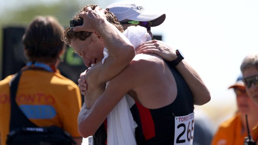 Evan Dunfee (right) and Inaki Gomez embrace after the pair finished 1-2 in Pan Am Games men's race walk on July 19, 2015.