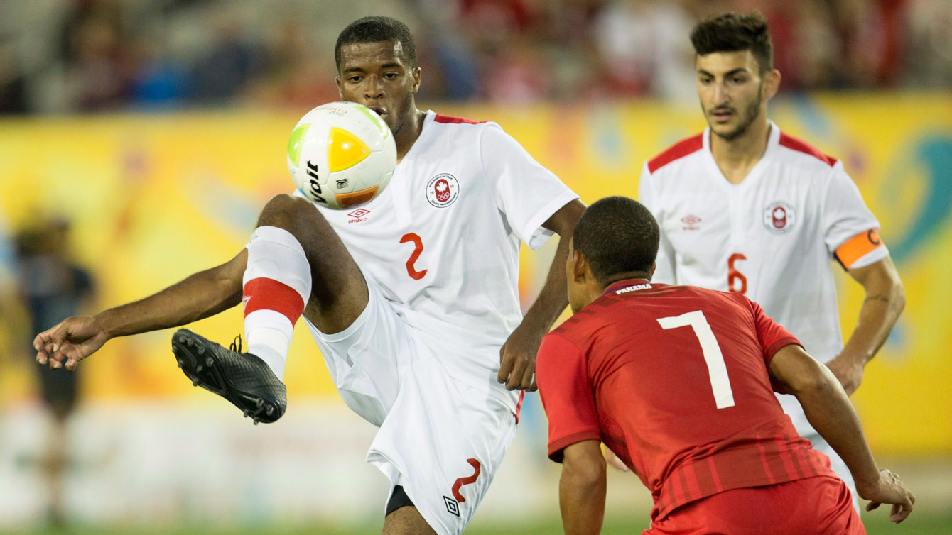 Jonathan Grant of Canada (number 2 in white) tries to knock the ball past a Panama player in Pan Am Games on July 16, 2015.