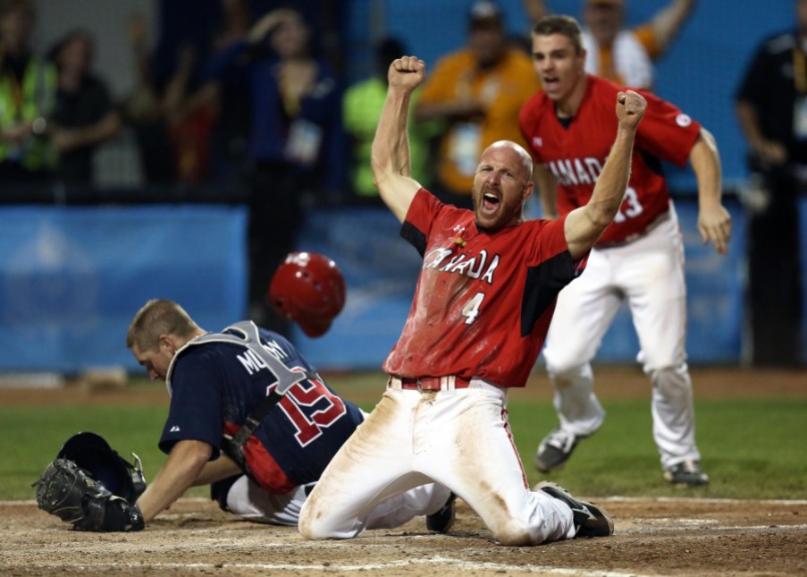 Men's baseball - TO2015 Peter Orr celebrates the extra inning gold medal-winning run over USA at the Pan Am Games men's baseball final (COC photo by Greg Kolz).