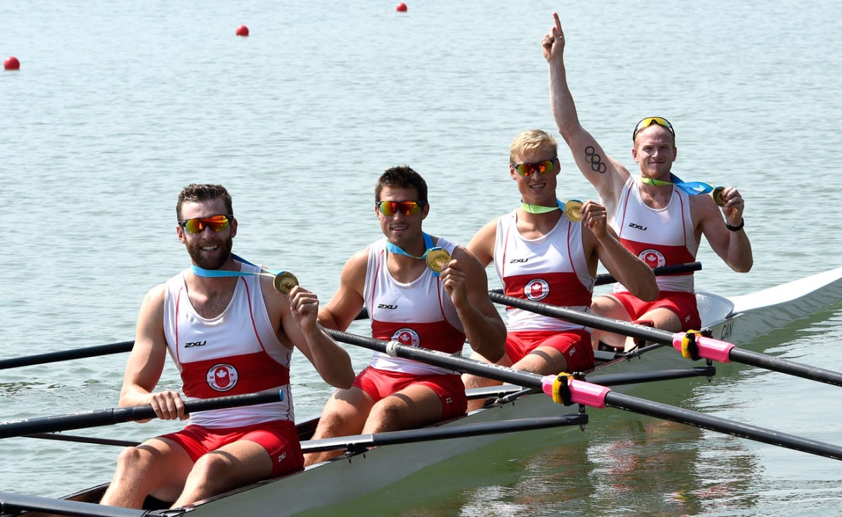 The men's coxless four crew celebrate their gold medal. From left to right: Conlin McCabe, Kai Langerfeld, Tim Schrijver and Will Crothers. (Photo: Jason Ransom)