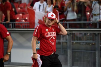 Harnett shows off some Team Canada swag while cheering on the rugby teams.