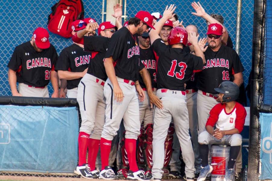 Team Canada baseball - TO2015 Team Canada celebrates another home run against Puerto Rico in men's baseball (Jeffrey Sze/COC).