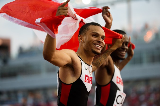 Team Canada celebrates its short-lived victory in mens's 4x100 relay before disqualification during the 2015 Pan Am Games in Toronto, July 25 2015 (John Fernandez for COC).