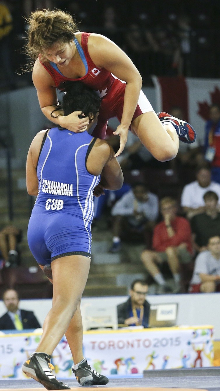 Justine Di Satsio (red) of Coquitlam, B.C. defeated Lisset Hechavarria of Cuba in the freestyle wrestling 75 kg.