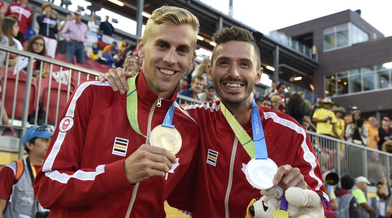 Matt Hughes and Alex Genest pose with their medals