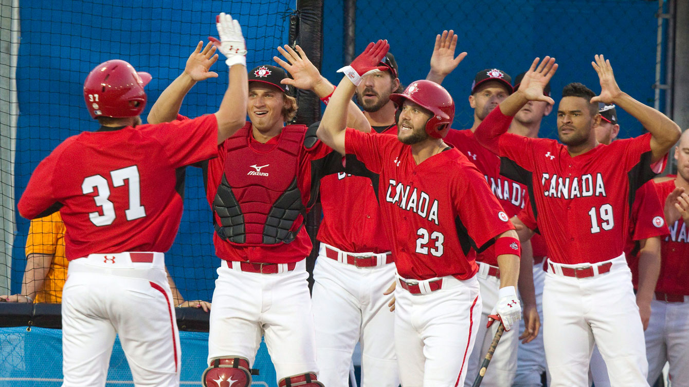 Canada's Jordan Lennerton (37) is congratulated hiiting a three run home run against the Dominican Republic at the Pan Am Games in Ajax, Ontario - Saturday, July 11, 2015.