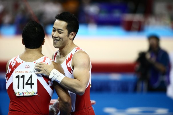 Ken Ikeda celebrates with Hugh Smith after competing in horizontal bars