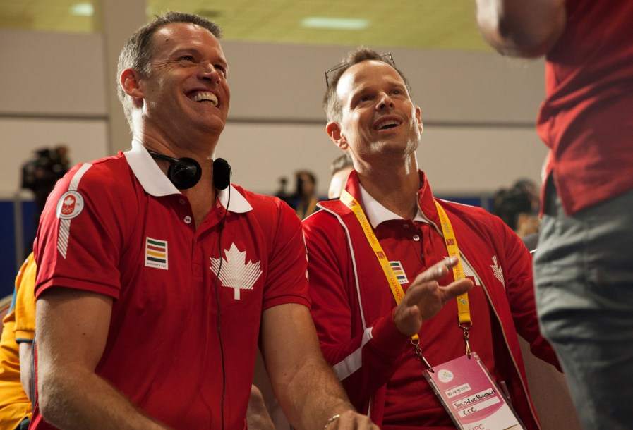 Mark Tewksbury (left) and Jean-Luc Brassard are still doing what they can to support Team Canada.