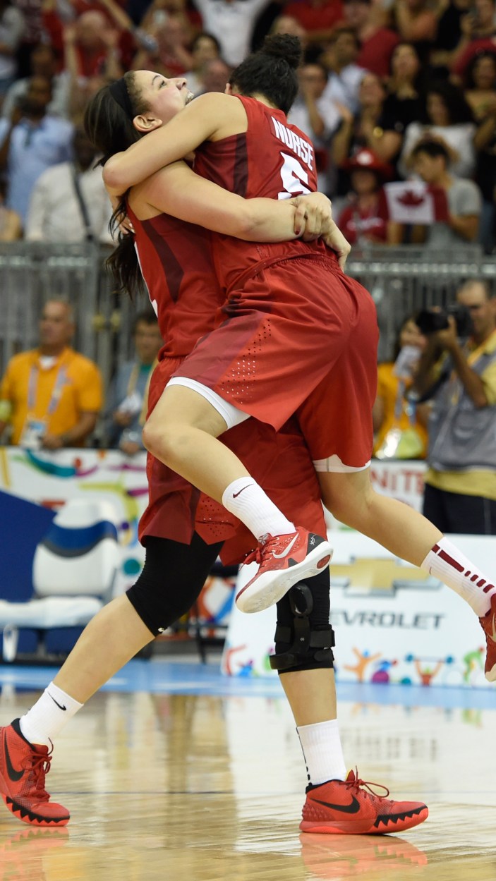 Kia Nurse jumps into the arms of a teammate as Canada beats USA 81-73 for Pan Am Games basketball gold on July 20, 2015.