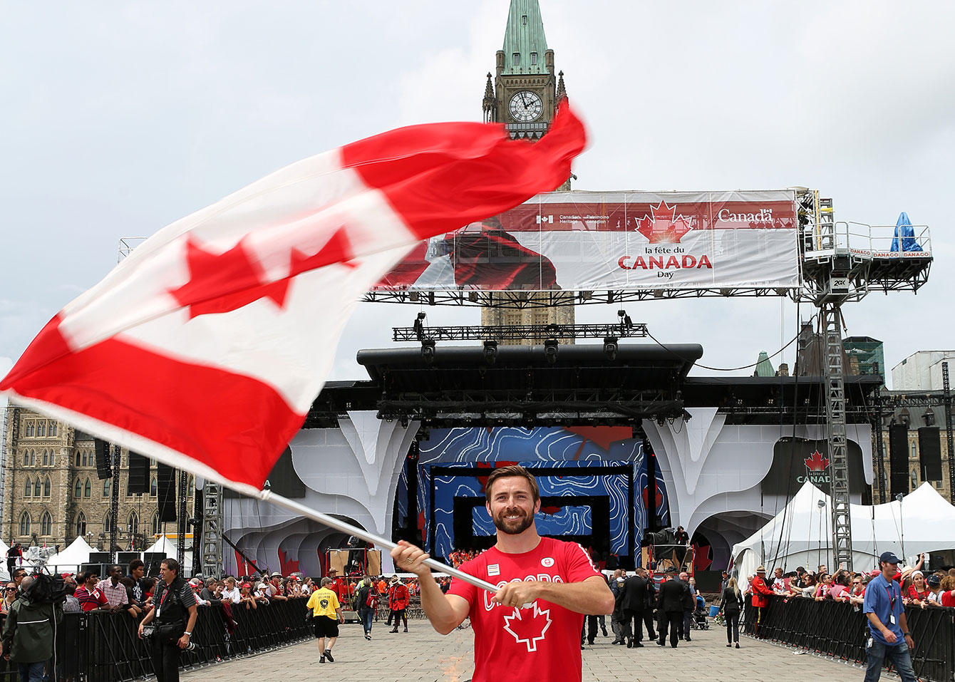 Mark Oldershaw waves the flag prior to Canada Day celebrations on Parliament Hill on July 1, 2015 (Greg Kolz for Canadian Olympic Team). 