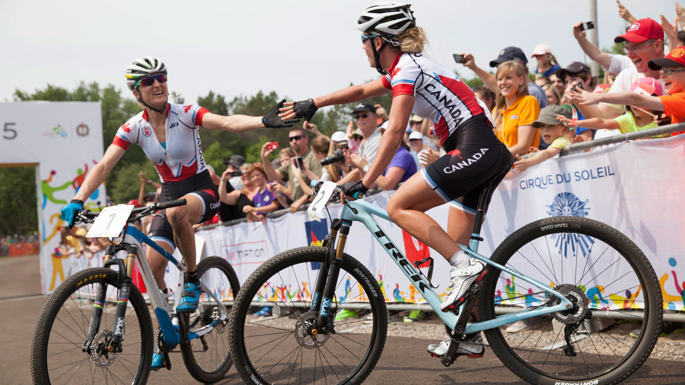 Catharine Pendrel (left) and Emily Batty congratulate each other following Pan Am Games mountain bike race. Batty was first, Pendrel second on July 12, 2015.