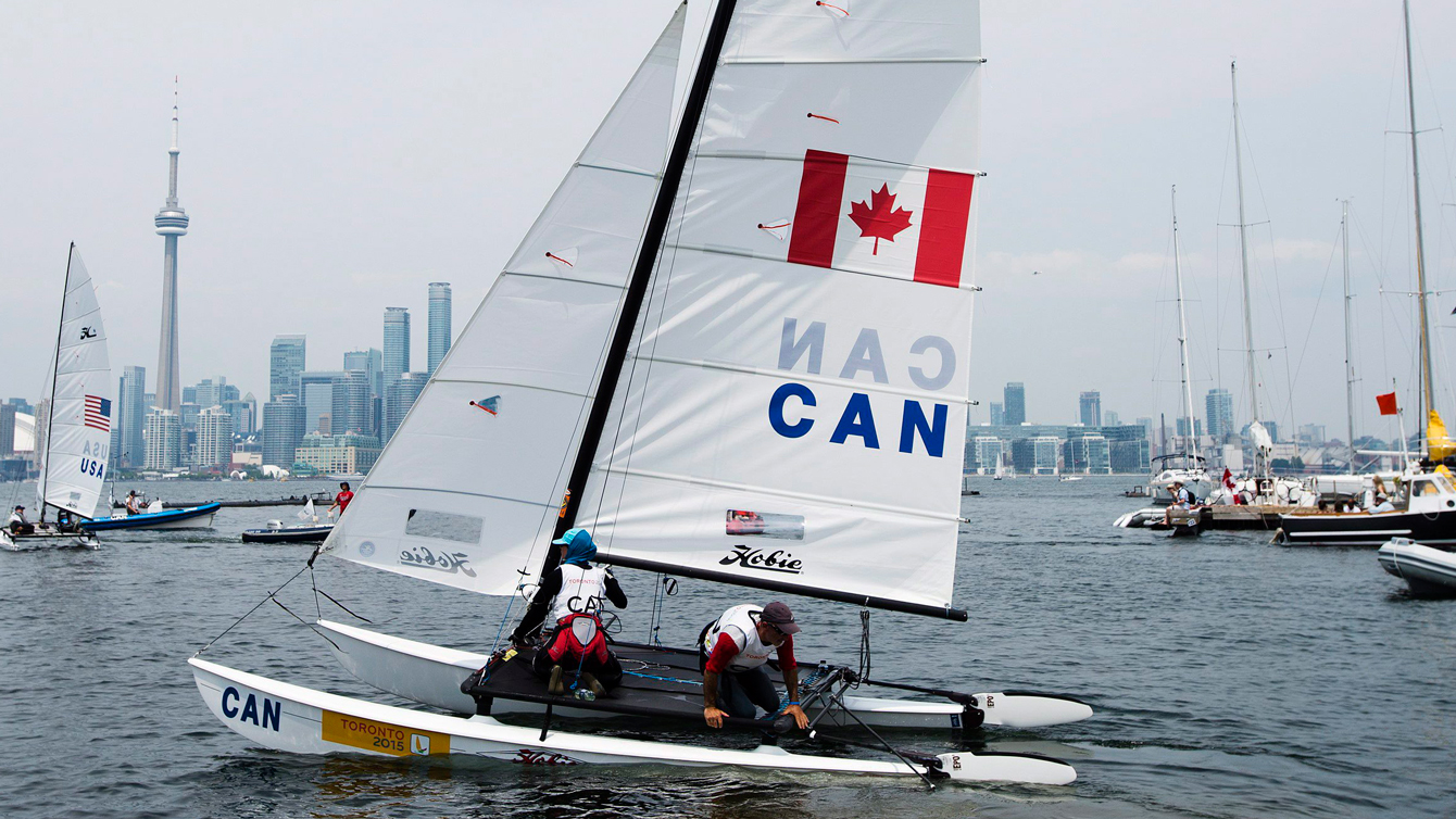 Dan Borg, right, and Liana Giovando launch their hobie 16 sailboat as they get ready to compete during the Pan Am Games