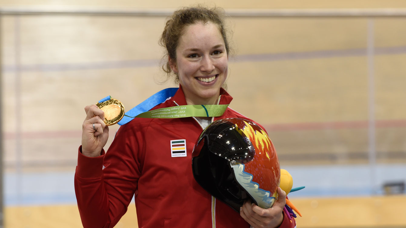 Monique Sullivan holds up her Pan Am Games gold medal and 'Fire Leaf' helmet from the Helmets for Heroes program on July 17, 2015.