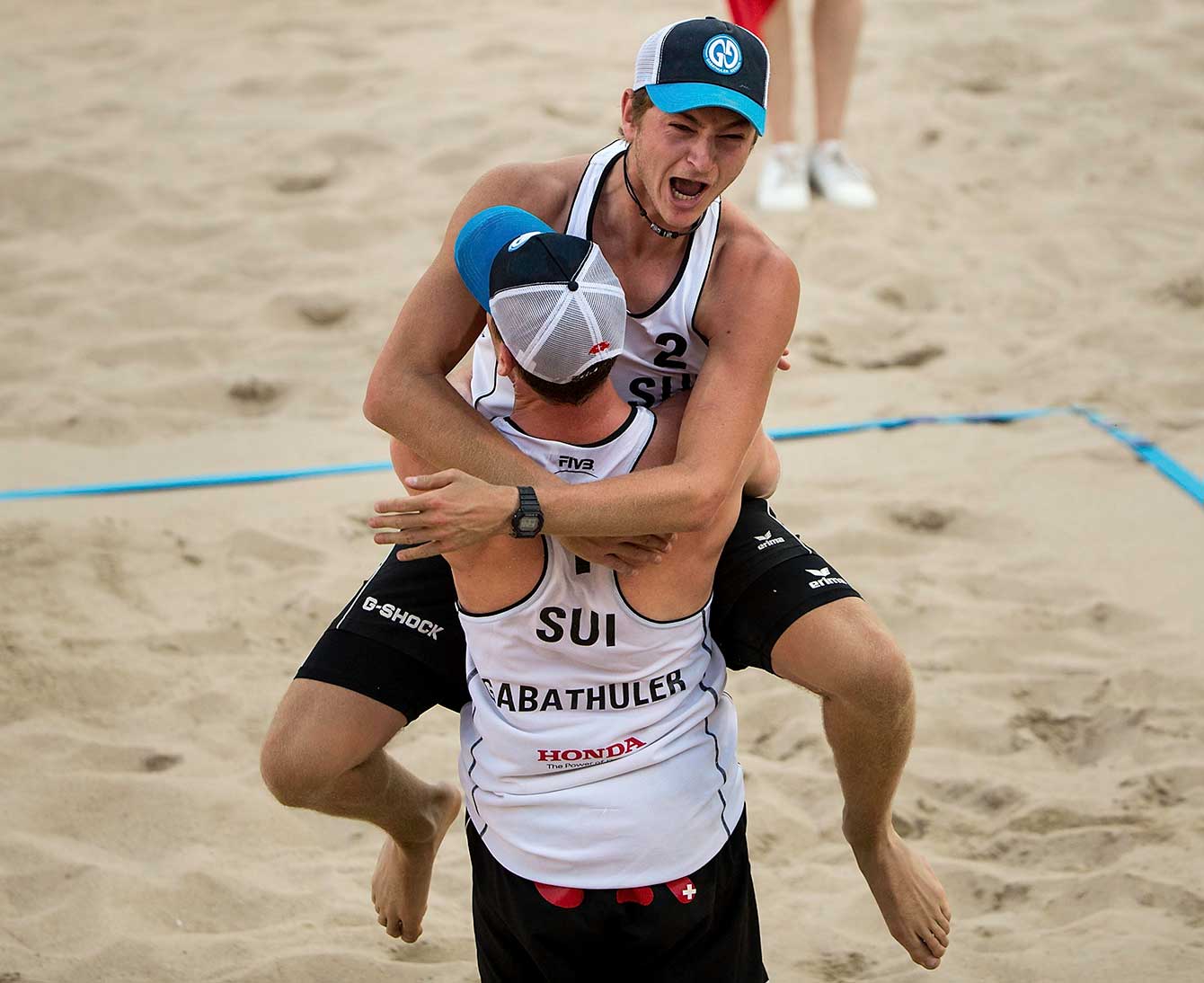 The Swiss team celebrates after knocking off Canada. (Photo: FIVB)
