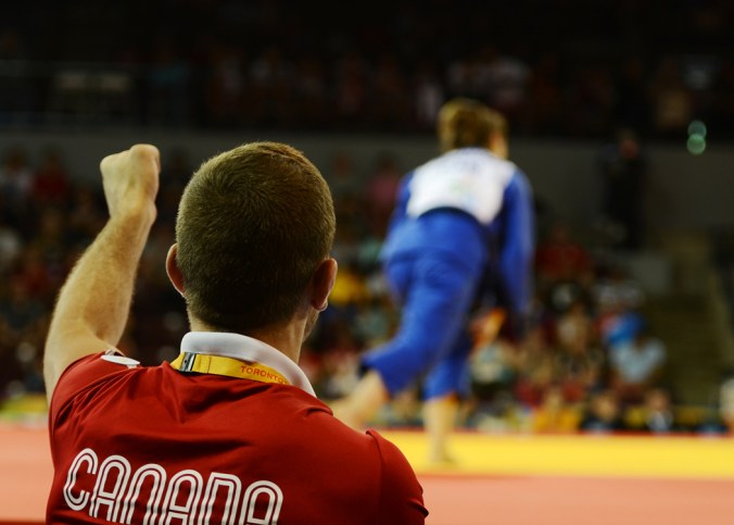 Stefanie Tremblay's coach urges her on during judo in Mississauga at the Pan Am Games (COC Photo by Jason Tse).