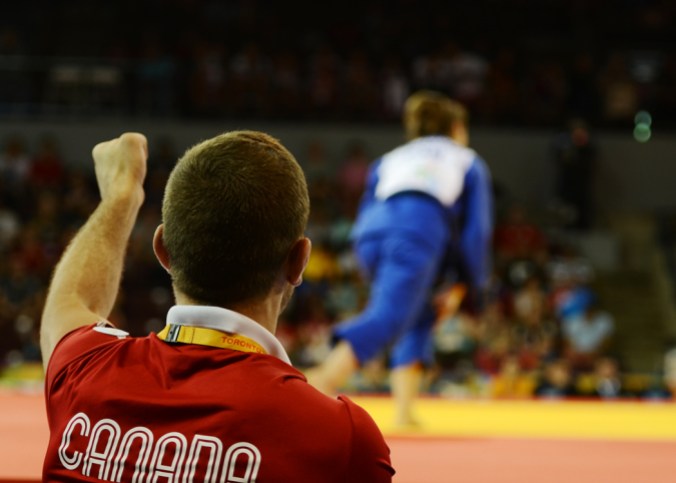 Stefanie Tremblay, Judo - TO2015 Stefanie Tremblay's coach urges her on during judo in Mississauga at the Pan Am Games (COC Photo by Jason Tse).