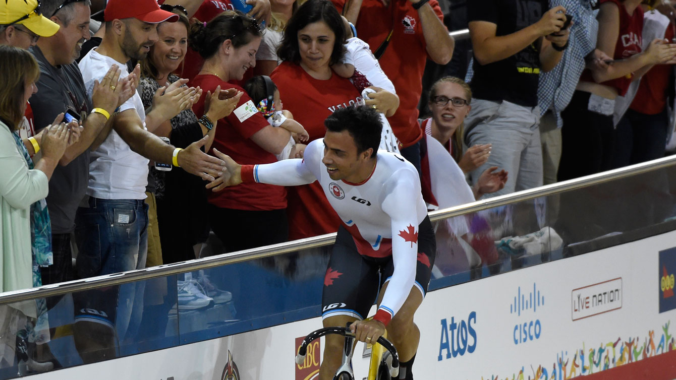 Joseph Veloce bikes over to the crowd after winning the men's team pursuit at the Pan Am Games on July 16, 2015.