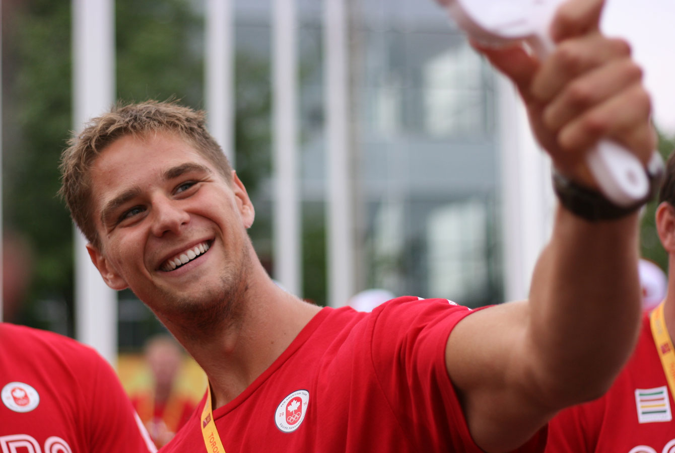 Kayaker Pierre-Luc Poulin tests out the Twitter mirror at the athletes' village welcome for TO 2015 Pan American Games (Photo: Alexandra Fernando).