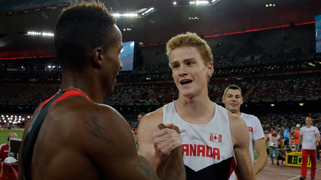 Shawn Barber shares a moment with Raphael Holzdeppe after the two men won gold and silver, respectively in pole vault at the World Championships in Beijing on August 24, 2015. 
