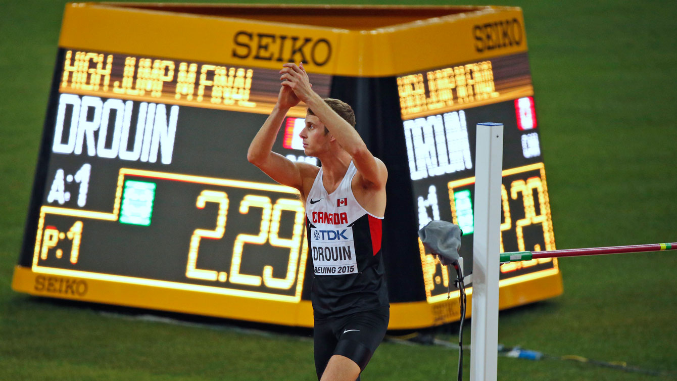 Derek Drouin applauds the crowd after clearing the 2.29m mark in the high jump competition at the world championships in athletics on August 30, 2015. 