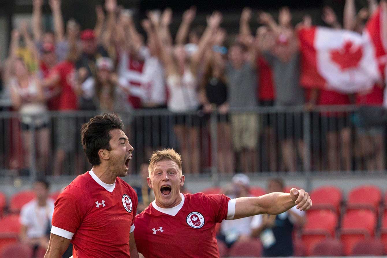 Nathan Hirayama (left) and John Moonlight (captain) celebrate their rugby sevens Pan Am Games gold at the whistle.