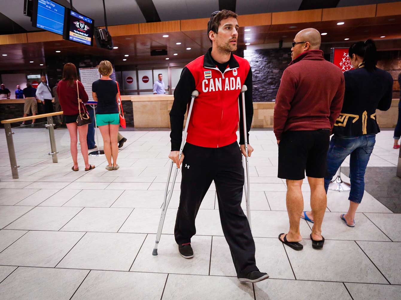 Denny Morrison walks on crutches on May 25th at the Calgary International Airport. 
