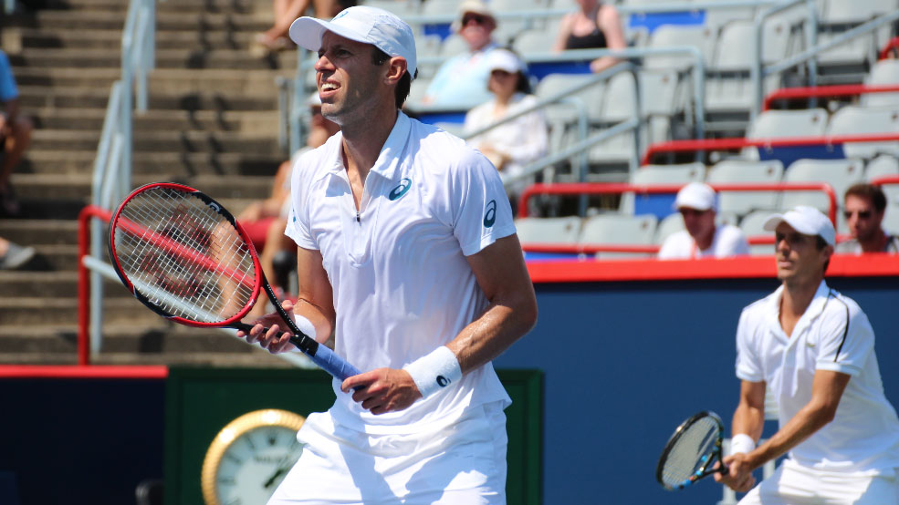 Daniel Nestor, ahead of partner Edouard Roger-Vasselin, waits for a serve at the 2015 Rogers Cup men's doubles final.