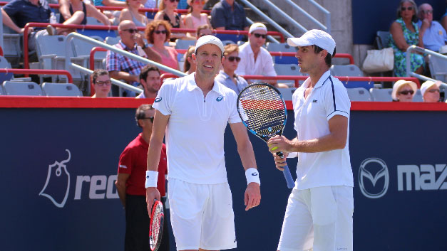 Daniel Nestor and Edouard Roger-Vasselin discuss strategy for the next point during the 2015 Rogers Cup final in men's doubles.