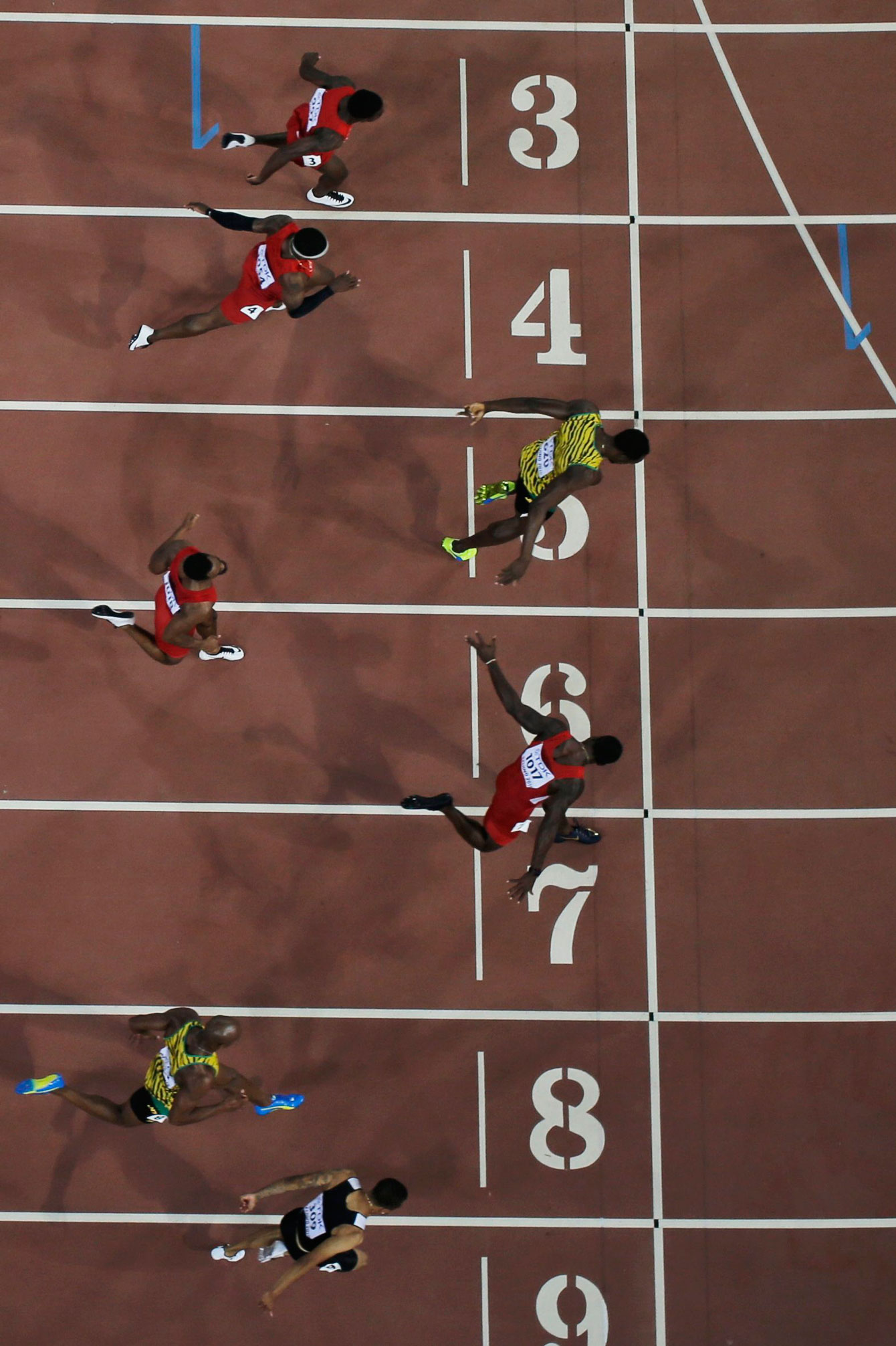Andre De Grasse (lane nine) leans in for bronze as Usain Bolt (5) and Justin Gatlin (7) battle for gold and silver in the closing moments of the 100m final at the IAAF World Championships in Athletics in Beijing, China on August 23, 2015. 