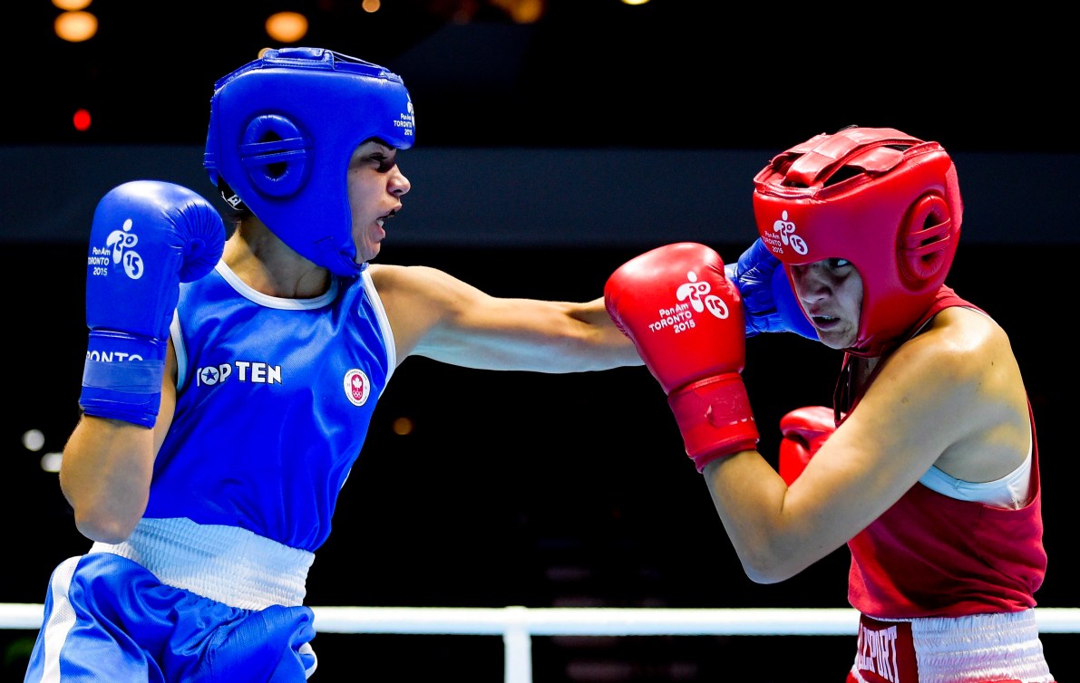 Caroline Veyre, left, of Canada, competes against Dayana Sanchez, of Argentina, in the women's 57-60kg lightweight gold medal boxing final during the Pan American Games in Oshawa, Ont., on Saturday, July 25, 2015. Veyre won gold. THE CANADIAN PRESS/Nathan Denette