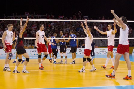 Members of the Canadian men's volleyball team celebrate the match-winning point