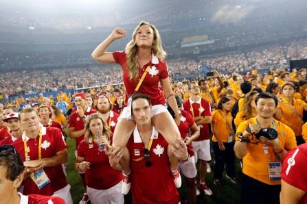 Rosannagh MacLennan, Joshua Binstock Canadian athletes Rosannagh MacLennan sits on the shoulders of Joshua Binstock as they listen to the entertainment