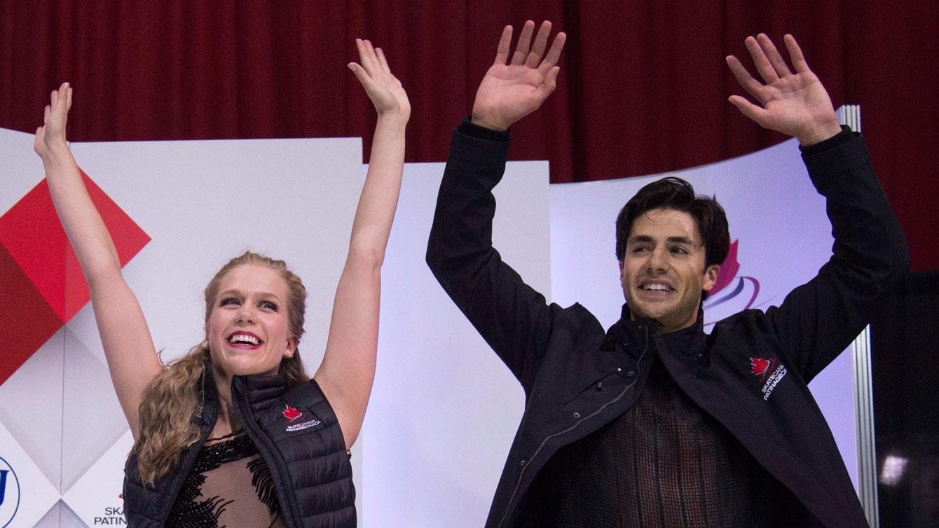 Kaitlyn Weaver and Andrew Poje celebrate as their final scores are announced at Skate Canada International on October 31, 2015. 