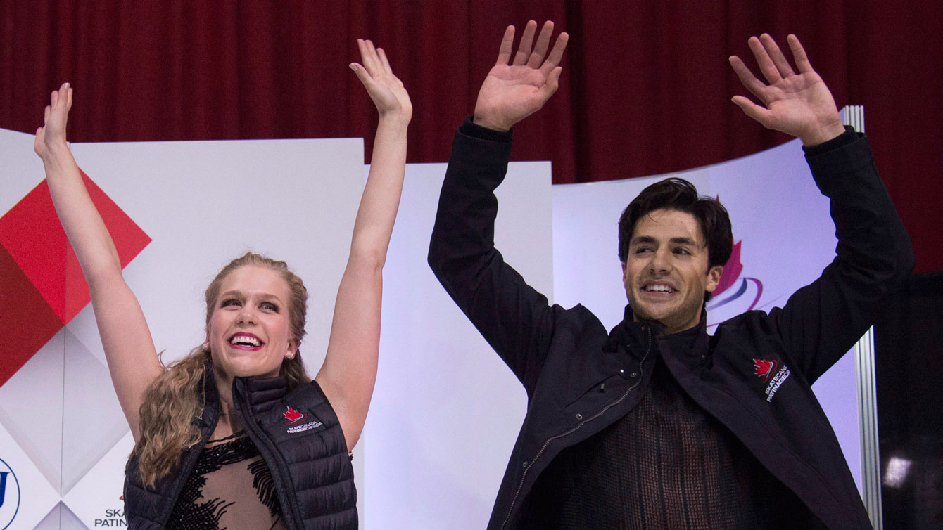 Kaitlyn Weaver and Andrew Poje celebrate as their final scores are announced at Skate Canada International on October 31, 2015.