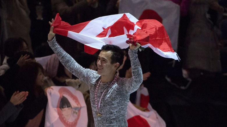 Patrick Chan takes a lap with the Canadian flag on October 31, 2015 after finishing first on his return to competition at Skate Canada International.