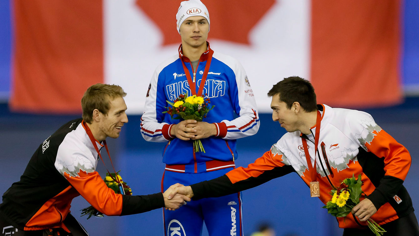 William Dutton (left) shakes hands with teammate and third-place finisher Alex Boisvert-Lacroix after the second World Cup 500m of the weekend in Calgary on November 15, 2015.