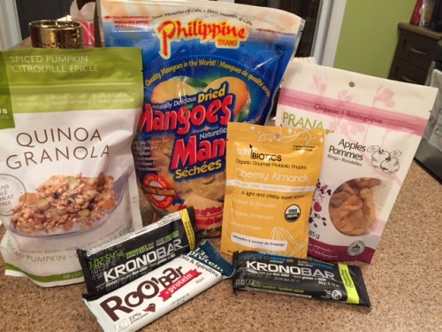 Assorted snacks Assorted snacks, including dried mangos, dried apple, quinoa granola for breakfast, almonds, protein bars.
