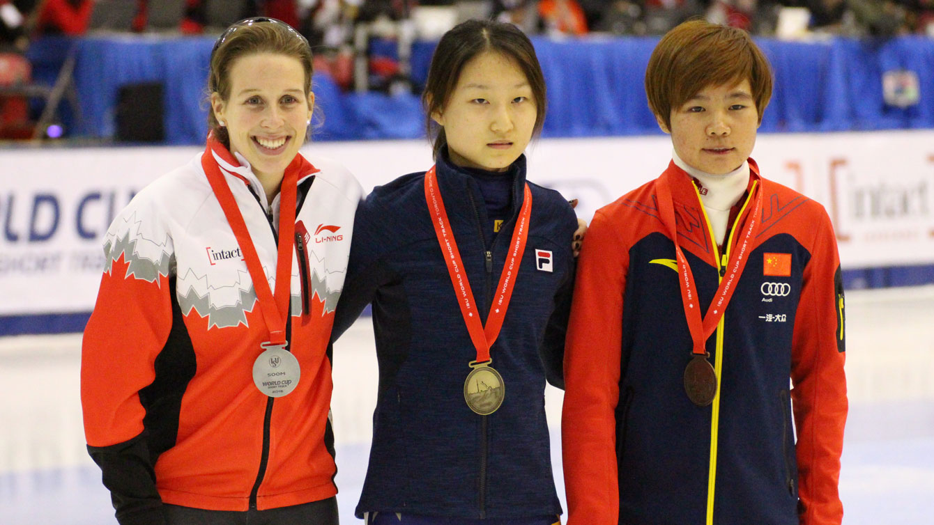 Marianne St-Gelais (left) accepts her silver medal after losing by one thousandth of a second to Choi Minjeong (centre) of South Korea in the 500m World Cup final in Toronto on November 8, 2015. 