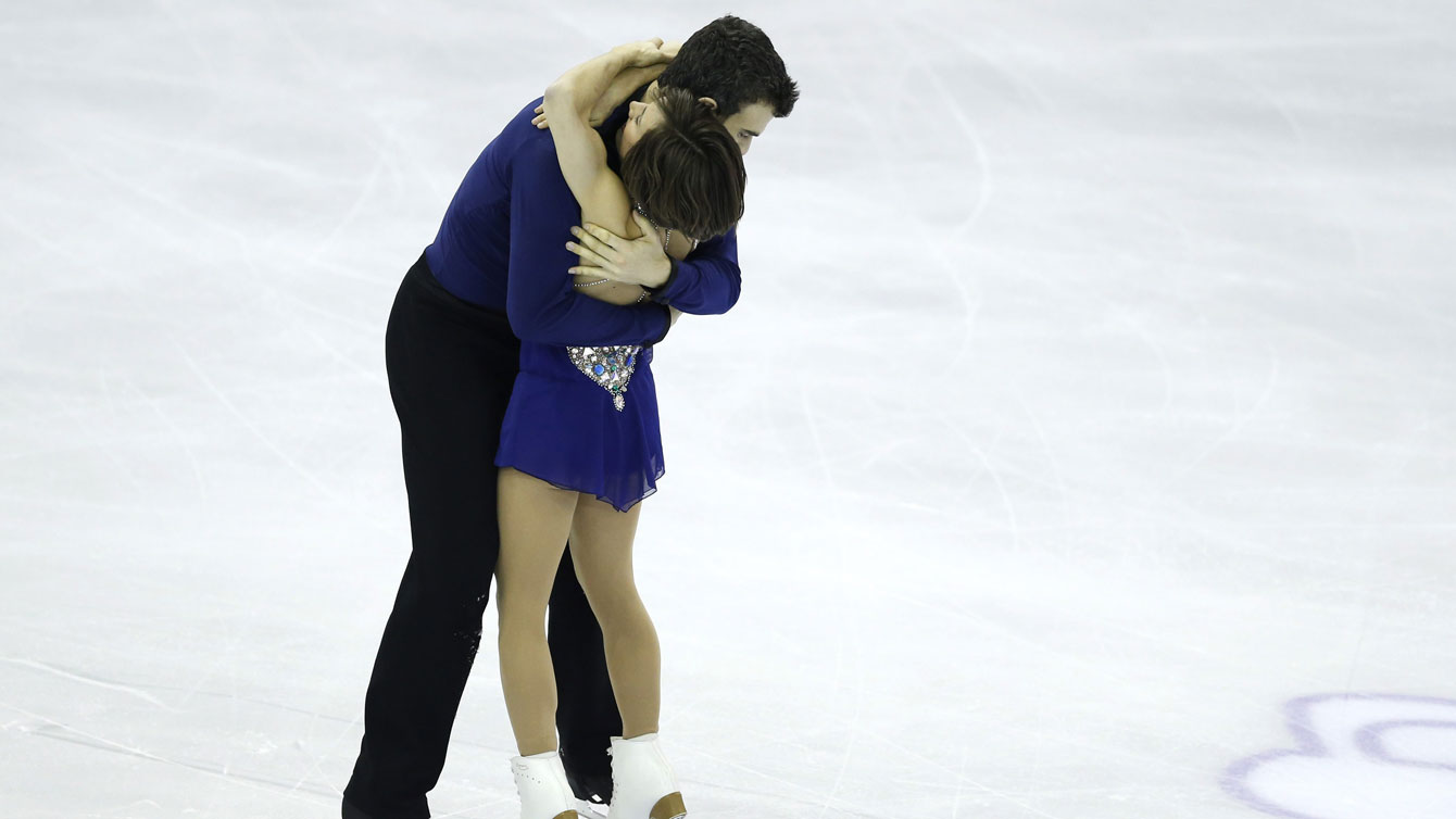 Meagan Duhamel and Eric Radford embrace at the ISU Grand Prix Final following the free skate on December 11, 2015 in Barcelona. 