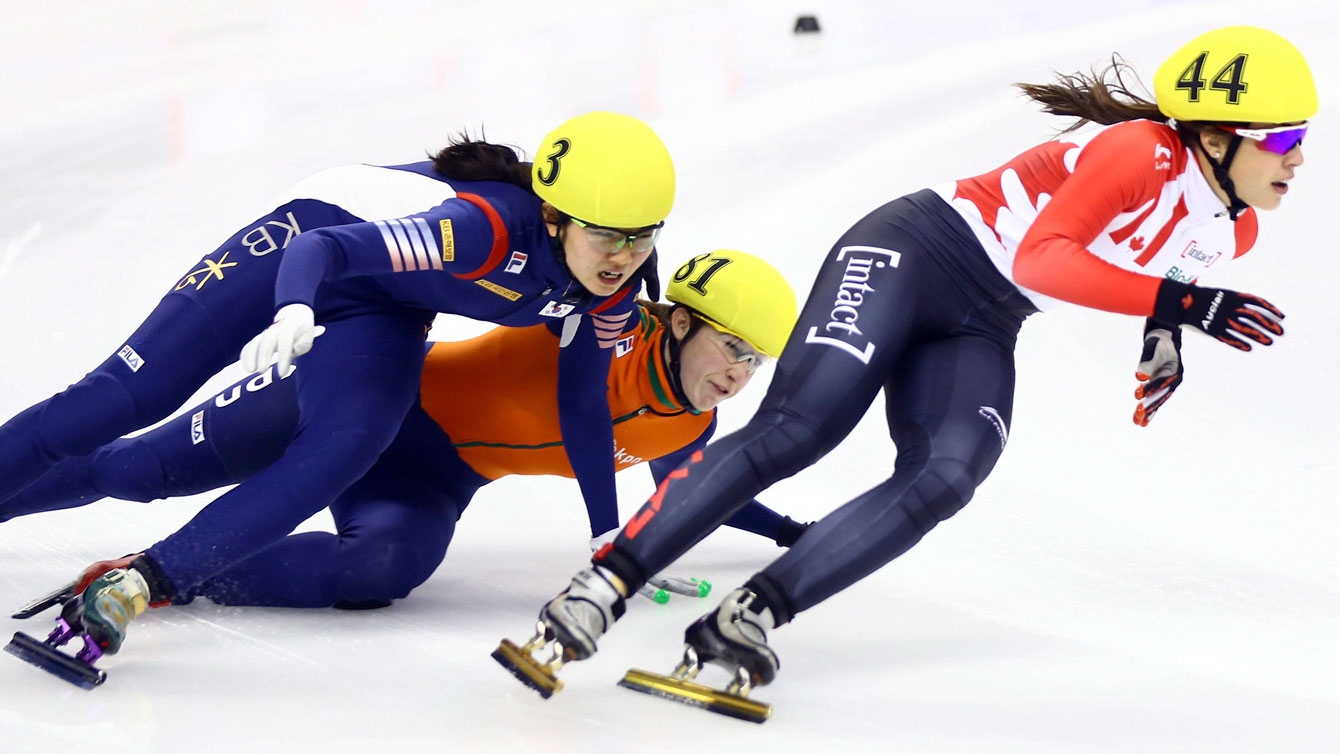 Valerie Maltais skates ahead of falling competitors at the World Cup 1000m final in Shanghai, China on December 12, 2015. 