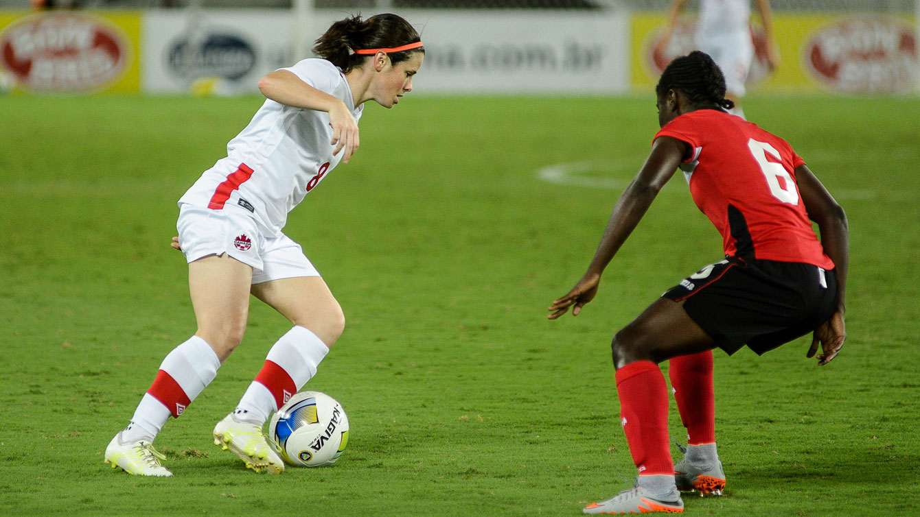 Diana Matheson (left, in white) in action against Trinidad and Tobago at the International Tournament of Natal. Matheson opened the scoring in a 4-0 win for Canada on December 13, 2015 (Photo: Vlademir Alexandre/Allsports).