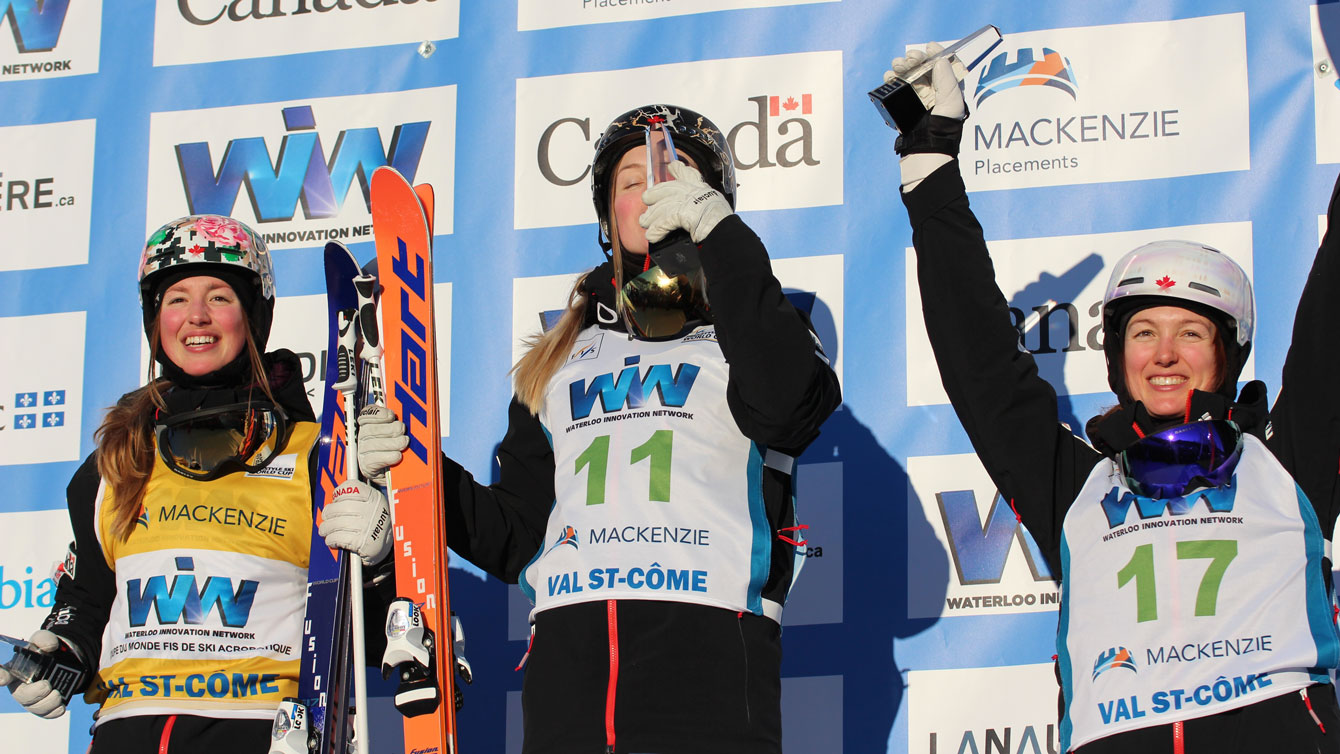 (L-R) Chloe, Justine and Maxime Dufour-Lapointe celebrate their World Cup podium sweep at Val Saint-Come, Quebec on January 23, 2016. 