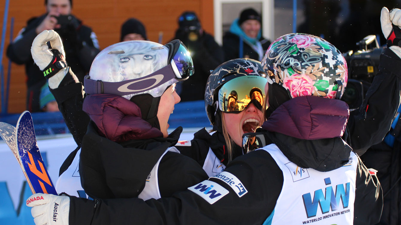 (L-R) Maxime, Justine and Chloe Dufour-Lapointe celebrate their World Cup podium sweep at Val Saint-Come, Quebec on January 23, 2016. 