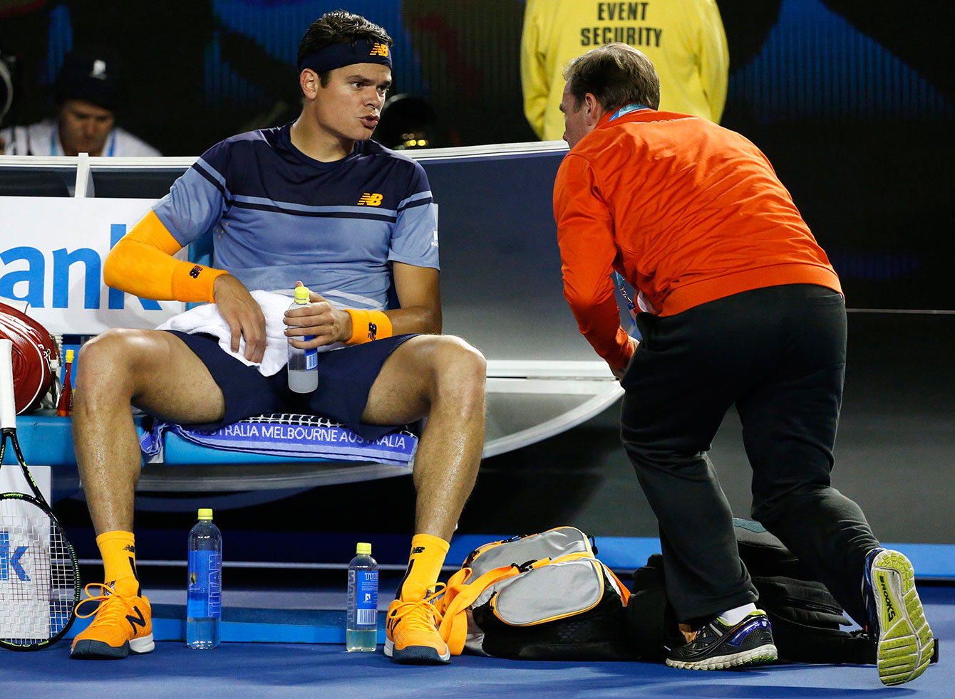 Milos Raonic speaks to a trainer during the fourth set at the Australian Open semifinals on January 29, 2016.