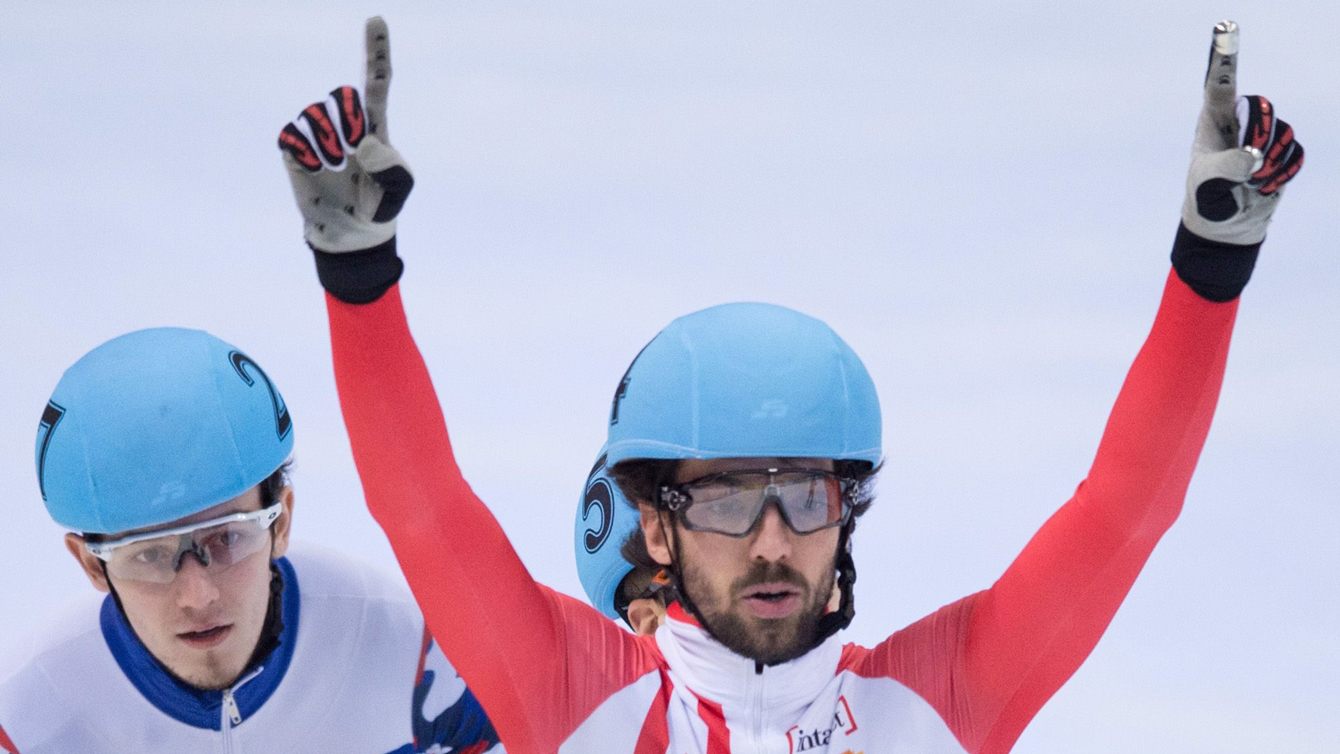Charles Hamelin celebrates while crossing the finish line during the men's 500 m final at the ISU Short track World Cup event in Dresden, Germany, Sunday Feb. 7, 2016.  